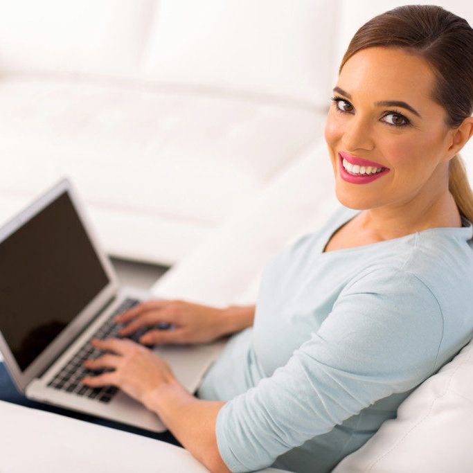 young woman with laptop computer at home